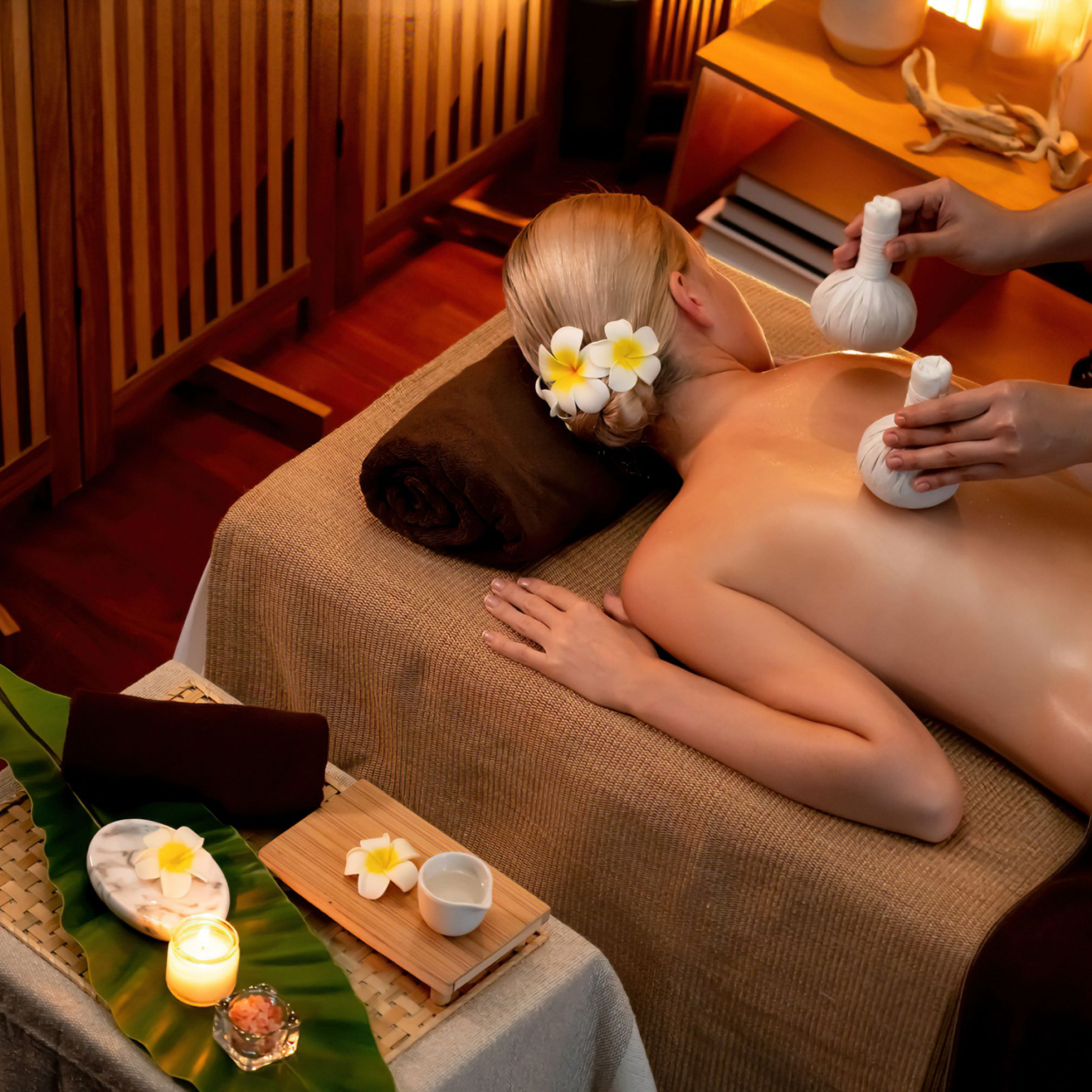 hot-herbal-ball-spa-massage-body-treatment-masseur-gently-compresses-herb-bag-woman-body-tranquil-serenity-aromatherapy-recreation-warm-lighting-candles-spa-salon